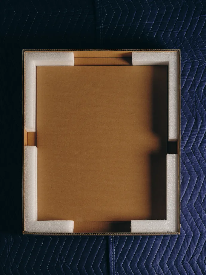 The wrapped work set into a foam-cornered board.